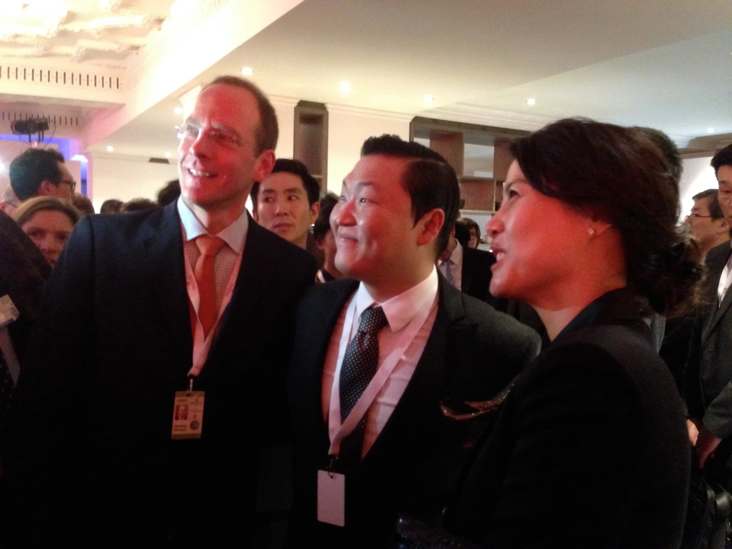 Geoffrey Kirkman laughing with other guests at a World Economic Forum reception in Davos